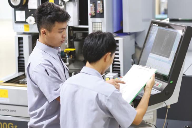 CAMV engineers reviewing precision components