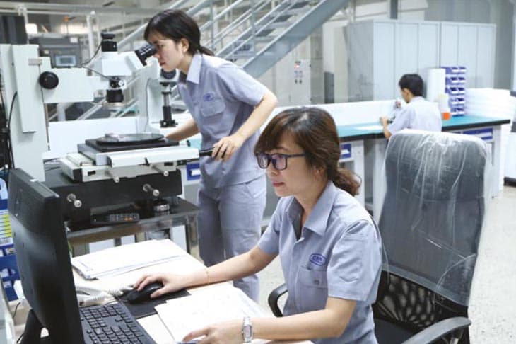 QC engineers measuring components at the workstation